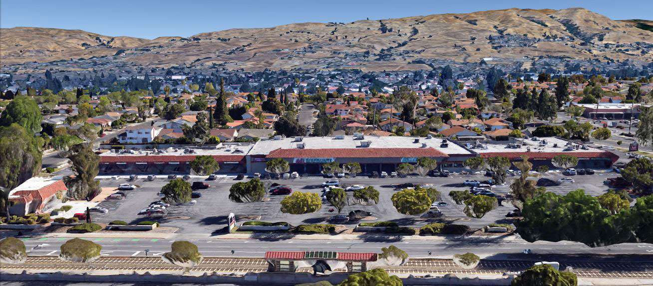 Aerial view of a strip mall and parking lot.